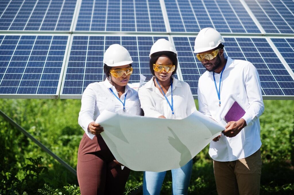african-american-technician-checks-maintenance-solar-panels-group-three-black-engineers-meeting-solar-station_627829-4806